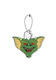 Gremlins car air freshener featuring the green and yellow head of Stripe with his white tuft of hair sticking up.
