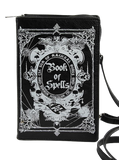 Black crossbody bag in the shape of a book featuring a white printed 'Book of Spells' illustration on the front, with a zip around zipper and black strap.