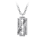 A silver-toned metal Judas Priest razor blade pendant necklace with engraved "British Steel" text and logo, suspended from a matching chain.