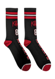 A pair of black crew socks with red and white stripes at the cuff, featuring the word 'Killers 81' in red and white,  and 'Iron Maiden' printed down the foot.