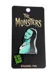The Munsters enamel glow-in-the-dark pin featuring Lily Munster's head and shoulders.