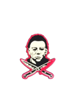 Halloween Movie Franchise enamel pin featuring head shot of Michael Myers with crossed knives dripping blood beneath him, outlined in a pinkish red color.
