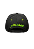 Black Type O Negative baseball cap shown from the back, featuring bright green embroidered text reading 'Dead Again' and matching green eye details on the back panels, displayed on a white 
background.