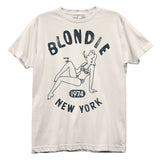 Close-up of Blondie NYC white t-shirt featuring a distressed illustration of a woman in a bikini lounging and smoking with the words "Blondie 1974 New York" around her, photographed flat on white background.