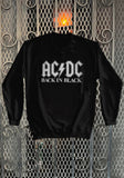 AC/DC Back in Black black sweatshirt featuring the band logo in large white letters with 'Back in Black' in white letters under it, displayed on a metal gate background.