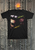 A black short-sleeve graphic t-shirt featuring a front print of the band 'Bad Brains' with their 'I Against I' album artwork, displayed flat against a metal mesh background.