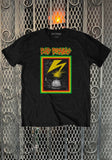 Bad Brains Banned in DC black t-shirt featuring artwork from the album and the band name logo in red, green, and yellow text, displayed on a metal gate background.