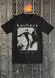 Bauhaus Bella Lugosi black t-shirt featuring album artwork of figure carrying a woman, displayed on a metal gate background.
