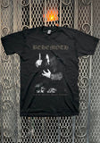 Front of Behemoth Ceremony of Wolves black t-shirt featuring album artwork along with bronze text 'And the forests dream eternally' below the image, displayed against a metal gate background.