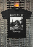 A black short-sleeve graphic t-shirt featuring the band name 'BURZUM' in white gothic font at the top and 'Filosofem' below a black-and-white album-style forest scene graphic, displayed against a decorative metal mesh backdrop.