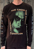 Black long sleeve t-shirt with 'The Crow' movie graphic in the design of Type-O Negative album October Rust with the words 'the crow' and 'nothing is trivial' around the corners of the image, on a model in front of a metal gate.