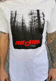 The Cure A Forest light heather grey t-shirt featuring artwork from the single along with the band logo in red, on a model against a metal gate background.