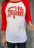 Death Original Logo white raglan t-shirt with red 3/4 sleeves featuring the band logo in red, on a model against a metal gate background.
