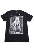 Dolly Parton Guitar black t-shirt featuring a black and white framed image of her posing with her guitar and white text 'Dolly Parton' above the image, displayed on a white background.