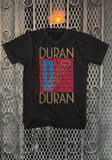 Duran Duran Seven and the Ragged Tiger black t-shirt featuring album artwork, displayed against a metal gate background.