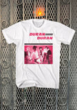 Duran Duran Debut Record white t-shirt featuring artwork from the album in pink, black, and white, displayed on a metal gate background.