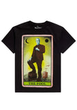 Herman Munster The Fool Tarot Card black t-shirt featuring a colorful image of the fool tarot card with Herman Munster on it, displayed on a white background.