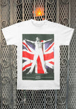 Freddie Mercury Draped in the Union Jack white t-shirt featuring an image of him shirtless with the union jack flag held open behind him, displayed on a metal gate background.