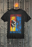 Black Guns n' Roses Use Your Illusion t-shirt featuring the album cover artwork, on a metal gate background.