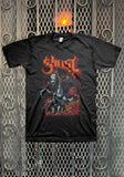 Ghost Charger black t-shirt featuring a large logo in orange with burgundy outline and a Papa on a charging horse illustration, displayed on  a metal gate background.
