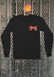 Front of Ghost Halloween Rider black long sleeve t-shirt featuring a small logo in orange with pink outline over the left chest area, displayed on a metal gate background.