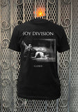 Joy Division Closer black t-shirt featuring album artwork, displayed on a metal gate background.