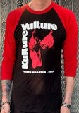 Front of Kulture Vulture black raglan t-shirt with red 3/4 sleeves featuring the store logo and large text "Kulture Vulture" and smaller text "French Quarter NOLA", on a model against a metal gate background.