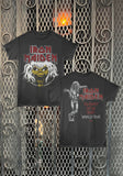 Front and back of an Iron Maiden band t-shirt displayed side-by-side against a decorative metal gate background. The left shows the front with the red and white 'Iron Maiden' logo and the yellow/green Monster graphic and the right shows the back with the monster standing and the words "the beast on the road world tour".