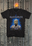 Iron Maiden Powerslave Mummy Eddie black t-shirt featuring artwork from the 12 inch single with Eddie as a mummy, displayed on a metal gate background.