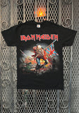 Iron Maiden Trooper black t-shirt featuring the band name in red with white outlines along with an illustration of the classic Trooper image, displayed against a metal gate background.