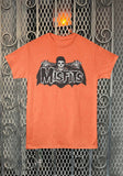 Misfits Crimson Ghost Bat orange t-shirt featuring a large band logo in white outlined letters on top of a black and white bat winged Crimson Ghost illustration, displayed on a metal gate background.