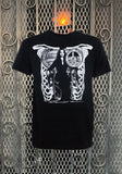 Morticia Addams black t-shirt featuring a black and white image of her sitting in a chair designed to look like a ribcage, displayed on a metal gate background.