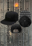 Three views of a black flat-brim baseball cap with 'Motorhead' embroidered on the front, an iron cross on the back, and the warpig design repeated on the underside of the bill.