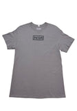 Nine Inch Nails grey t-shirt featuring a puffy NIN logo in the upper middle of the chest, displayed flat against a white background.