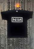 Nine Inch Nails Classic Logo black t-shirt featuring the classic logo in white across the chest, displayed on a metal gate background.
