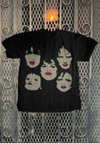 New York Dolls Faces black t-shirt featuring band mates faces in beige with pink lips, displayed on a metal gate background.
