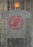 Rolling Stones '78 Tour heather grey t-shirt featuring their logo and the text 'Rolling Stones '78 Tour' in red, displayed against a metal gate background.