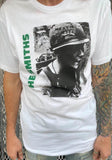The Smiths Meat is Murder white t-shirt featuring album artwork, on a model against a metal gate background.