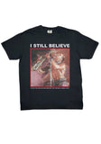 Black Lost Boys I Still Believe t-shirt featuring an image of Tim Cappello playing the saxophone, on a white background.
