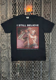 Black Lost Boys I Still Believe t-shirt featuring an image of Tim Cappello playing the saxophone, on a metal gate background.