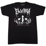 Close-up of Elvira Black Metal black t-shirt featuring a black and white image of her wearing batwings with her name in black metal script above the image and the text 'mistress of the dark' below the image, displayed against a white background.