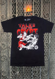 Tales from the Crypt Vampire Chick black t-shirt featuring a black, white, and red image of a vampire woman attacking a man with the text 'Tales from the Crypt' in stylized red lettering above the image, displayed against a metal gate background.