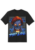 They Live Blue Alien black t-shirt featuring a large blue alien skull and crossbones illustration along with words repeating behind it 'conform, do not question authority, stay asleep, watch tv' in grey text and a large 'They Live' in blue text, displayed on a white background.