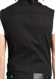 Back of black denim vest featuring two metal buttons at the waist and a leather fabric logo patch on the right, on a model against a white background.