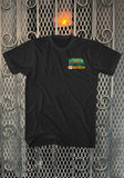 Front of Return of the Living Dead Uneeda black t-shirt featuring the Uneeda medical supply sign artwork on the left chest, displayed on a metal gate background.