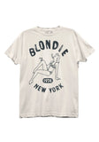 Blondie NYC white t-shirt featuring a distressed illustration of a woman in a bikini lounging and smoking with the words "Blondie 1974 New York" around her, photographed flat on white background.