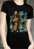 Creature of the Black Lagoon black t-shirt featuring a colorful image from the torso up of the creature along with Japanese lettering in blue and yellow, photographed on a model in front of a metal gate background.