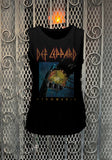 Def Leppard Pyromania black sleeveless t-shirt featuring the album artwork, photographed flat on a metal gate background.
