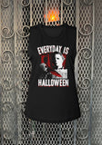 Black sleeveless Halloween movie t-shirt featuring a white and red image of Michael Myers holding a bloody knife and white with red blood dripping text in large letters that says 'Everyday is Halloween', on a metal gate background.