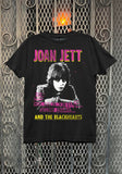 Black Joan Jett and the Blackhearts Second Chance March 15th 1981 show t-shirt featuring an image of her with large pink with yellow letters for 'Joan Jett' at the top and yellow letters for 'and the blackhearts' at the bottom, with pink knockout text for the second chance venue info in the middle, on a metal gate background.